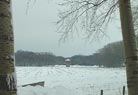 Afscheidsfoto van een ingesneeuwde toren over de velden vanaf de Marsdijk.