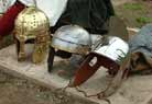 Three legionaries' helmets from different periods.