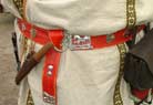 A beautiful belt with colorful stitches and tinned decorations all round.