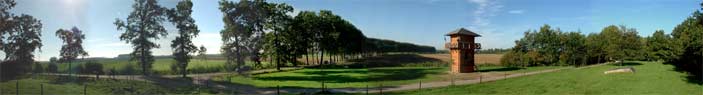 A 180-degree panoramic spread, the shadows are lengthening.