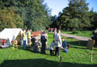 The campsite on a very early Sunday morning, and people are just returning from breakfast.