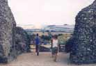 The end of the visit. Jan and Anie leaving through the old gate, with the Roman road visible just ahead.